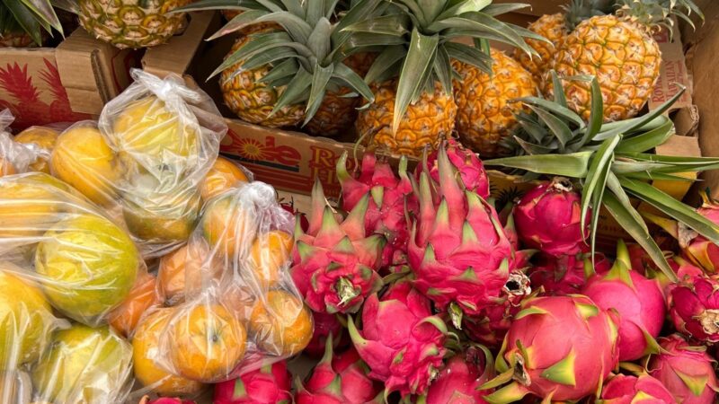 Pineapples, dragon fruit and citrus on a Kona farmers market table